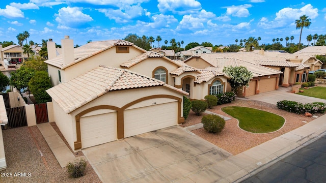 1146 W Sea Fog Dr, Gilbert, AZ 85233 - mediterranean / spanish-style house featuring concrete driveway, a garage, stucco siding, and a chimney