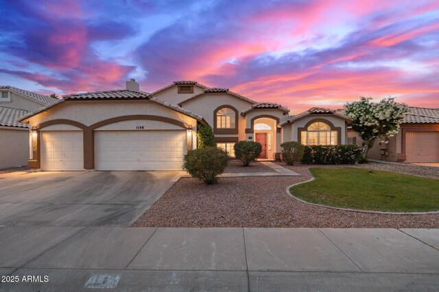 1146 W Sea Fog Dr, Gilbert, AZ 85233 - mediterranean / spanish house with an attached garage, stucco siding, concrete driveway, and a tile roof