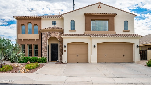 mediterranean / spanish-style home with a garage