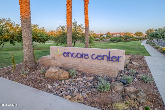 community sign featuring a lawn