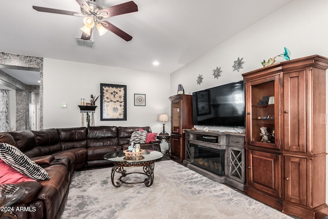 carpeted living room with ceiling fan