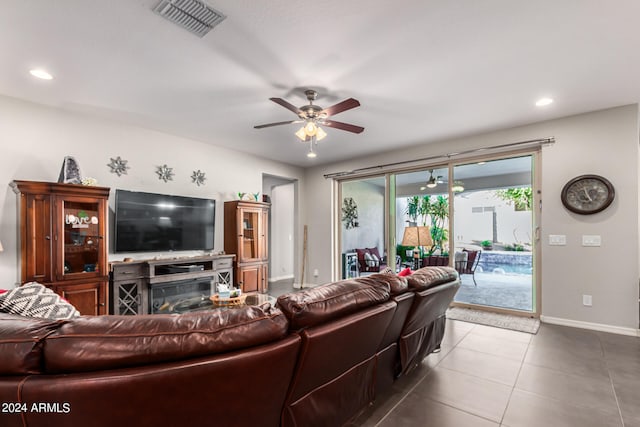 tiled living room featuring ceiling fan