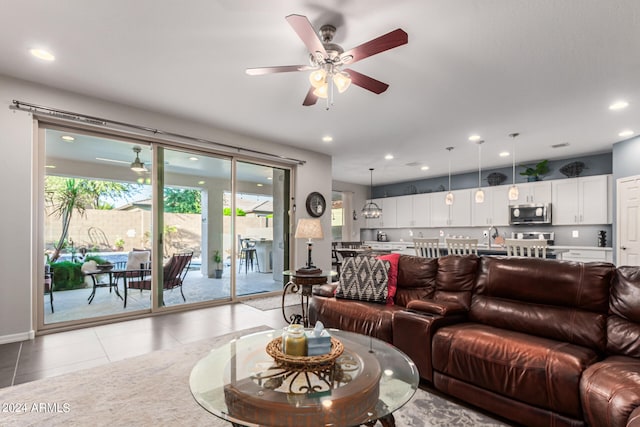 living room featuring ceiling fan and light tile patterned flooring