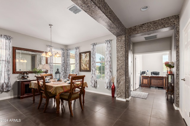 tiled dining space with a chandelier