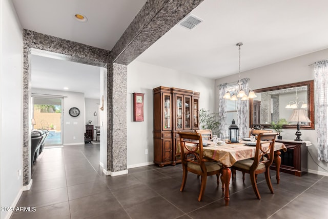 tiled dining area featuring a notable chandelier