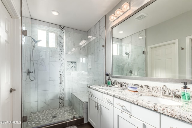 bathroom with walk in shower and vanity