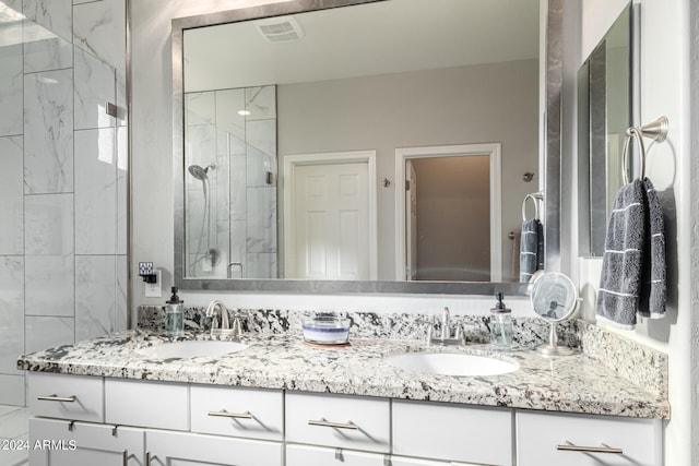 bathroom featuring vanity and a shower with door