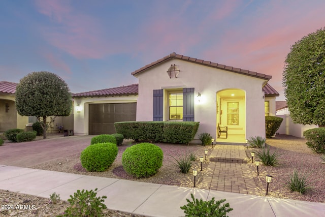 mediterranean / spanish-style house with a garage