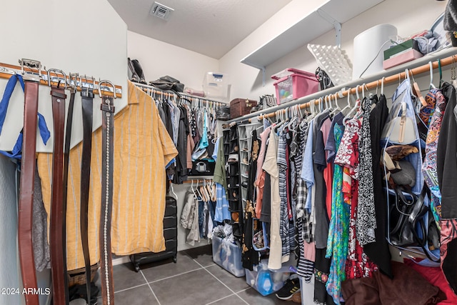 spacious closet featuring dark tile patterned floors