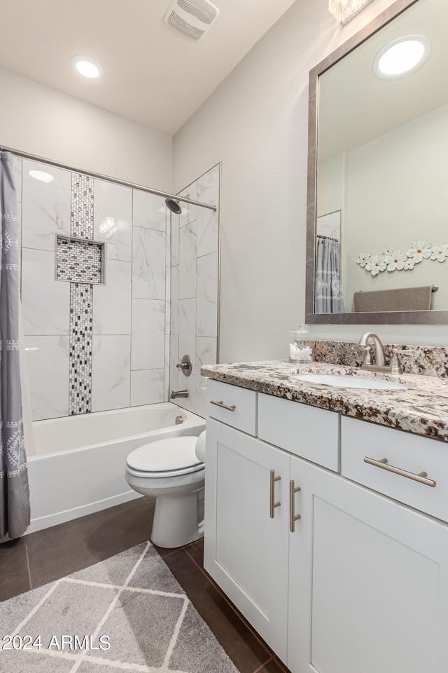 full bathroom featuring vanity, tile patterned flooring, toilet, and shower / bath combo