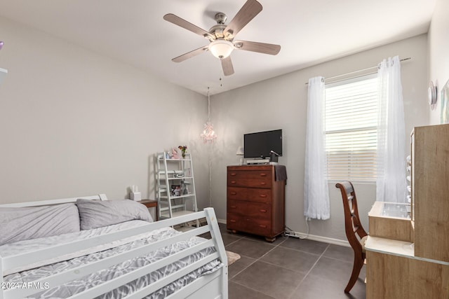 tiled bedroom featuring ceiling fan