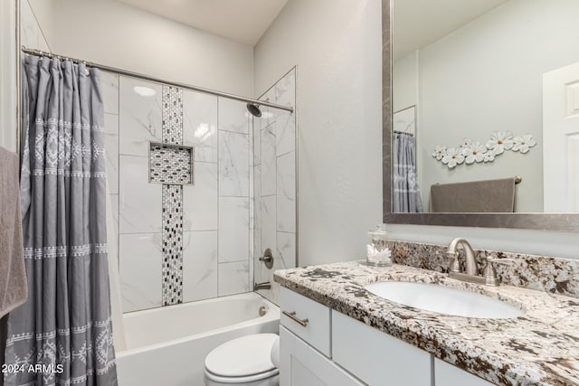 full bathroom featuring vanity, shower / tub combo, and toilet