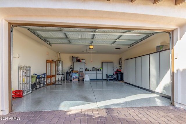 garage featuring gas water heater and a garage door opener