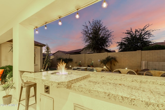 view of patio terrace at dusk