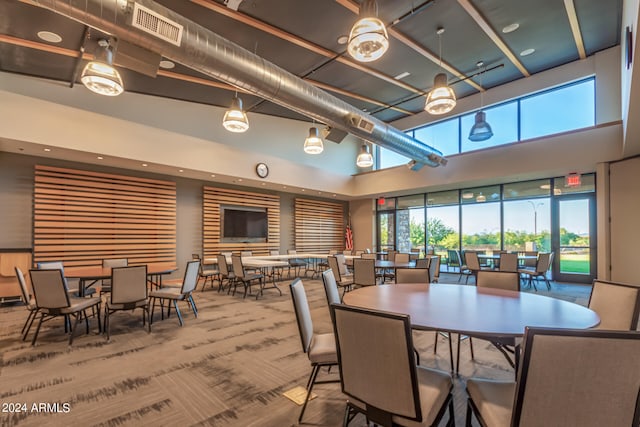 dining space with a towering ceiling