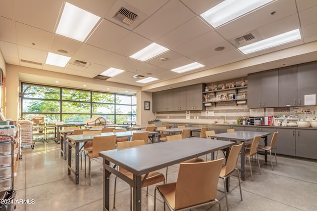 dining room featuring a drop ceiling and sink