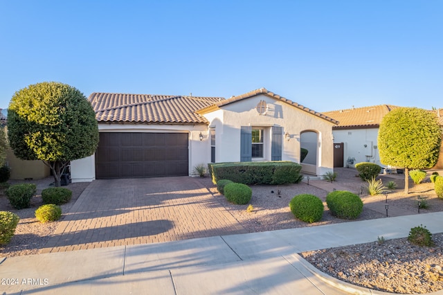 mediterranean / spanish home featuring a garage