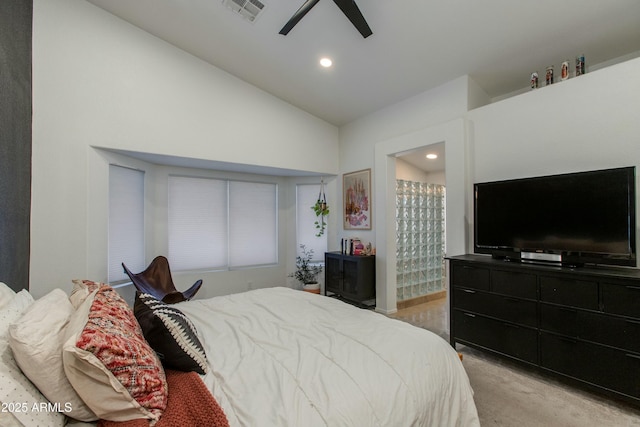 bedroom with ceiling fan, lofted ceiling, connected bathroom, and light carpet