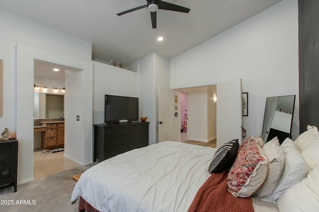 carpeted bedroom with ensuite bath, high vaulted ceiling, and ceiling fan