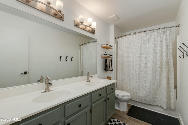 full bathroom with shower / tub combo with curtain, vanity, toilet, and wood-type flooring