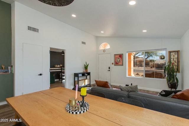 dining room featuring hardwood / wood-style flooring and high vaulted ceiling