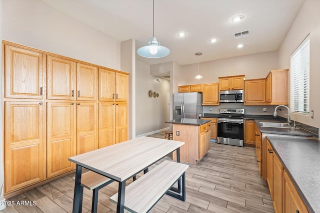 4667 E County Down Dr, Chandler, AZ 85249 - kitchen featuring stainless steel appliances, dark countertops, a center island, pendant lighting, and recessed lighting