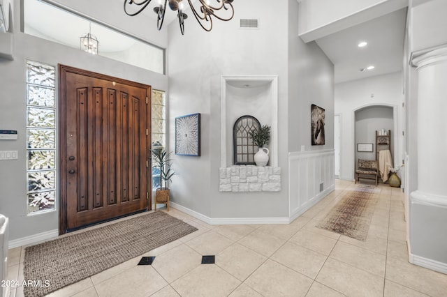 foyer featuring a chandelier and light tile patterned floors