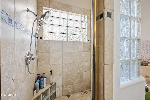 bathroom with tiled shower