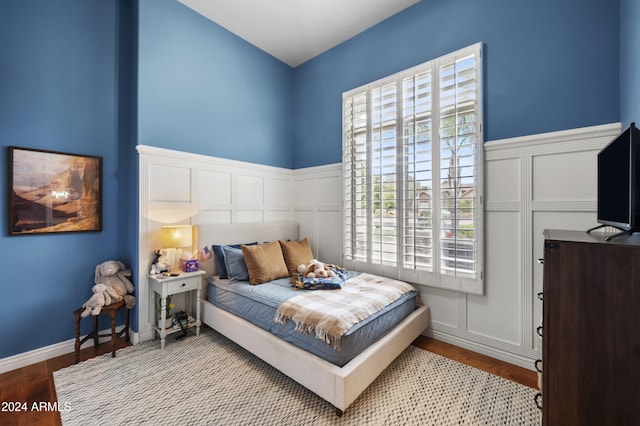 bedroom featuring hardwood / wood-style flooring and multiple windows