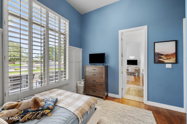 bedroom featuring hardwood / wood-style floors and ensuite bath