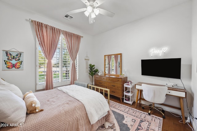 bedroom with multiple windows, ceiling fan, and dark hardwood / wood-style floors