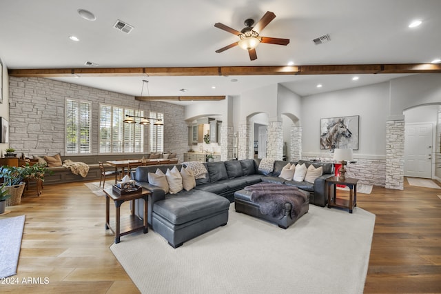 living room with ceiling fan, ornate columns, and light wood-type flooring