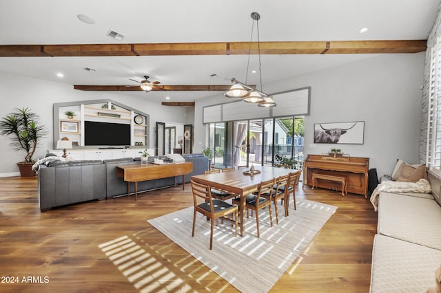 dining space with hardwood / wood-style floors, beamed ceiling, and ceiling fan