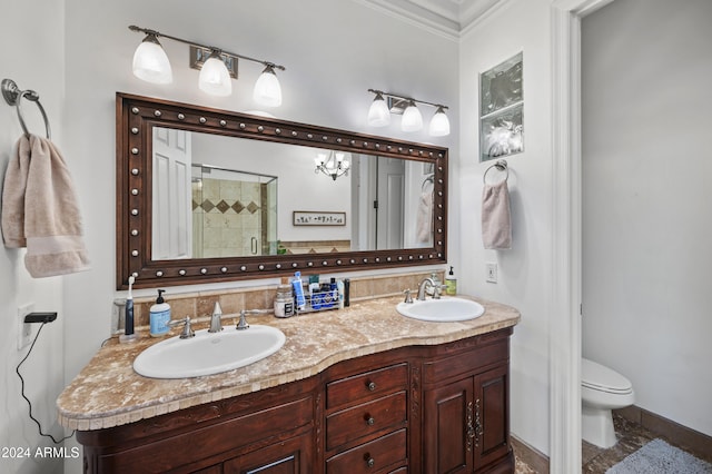 bathroom with toilet, vanity, walk in shower, and crown molding