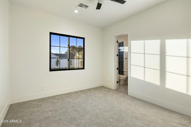 carpeted spare room featuring ceiling fan