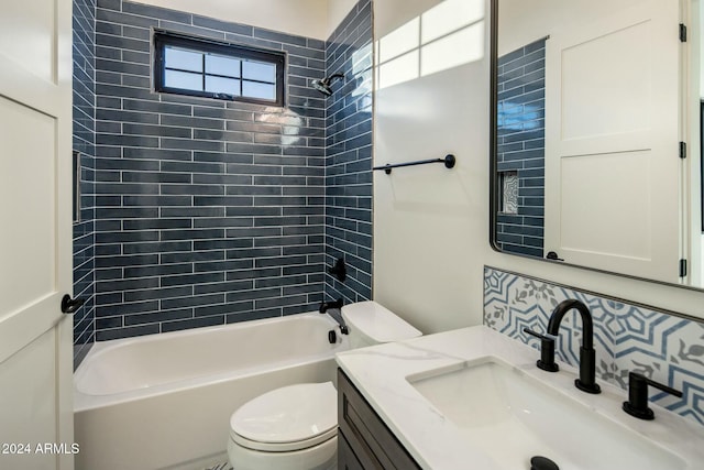 full bathroom with decorative backsplash, vanity, tiled shower / bath combo, and toilet