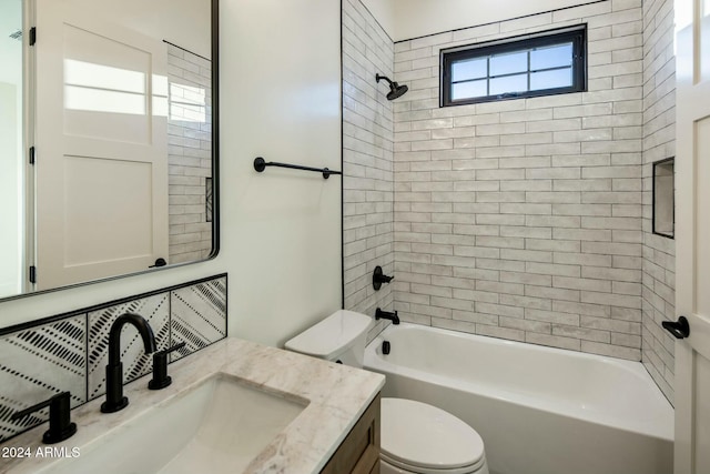 full bathroom featuring vanity, toilet, and tiled shower / bath