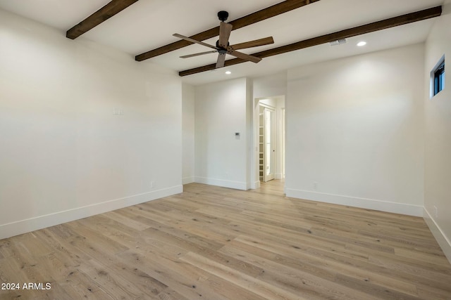 spare room featuring ceiling fan, beamed ceiling, and light hardwood / wood-style floors