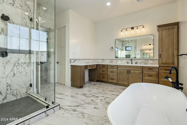 bathroom with vanity and shower with separate bathtub