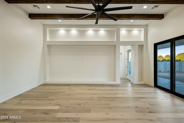 empty room featuring ceiling fan, light hardwood / wood-style flooring, and beamed ceiling