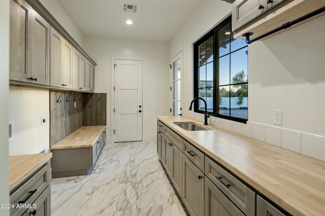 kitchen featuring wooden counters and sink