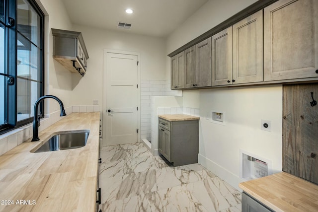 laundry room with sink, hookup for a washing machine, cabinets, and hookup for an electric dryer