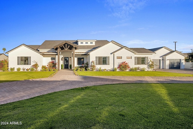 view of front of home featuring solar panels, a garage, and a front lawn