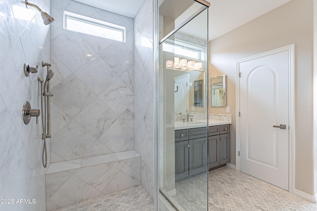 bathroom with a marble finish shower and vanity