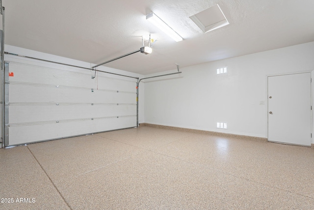 garage featuring a garage door opener and baseboards