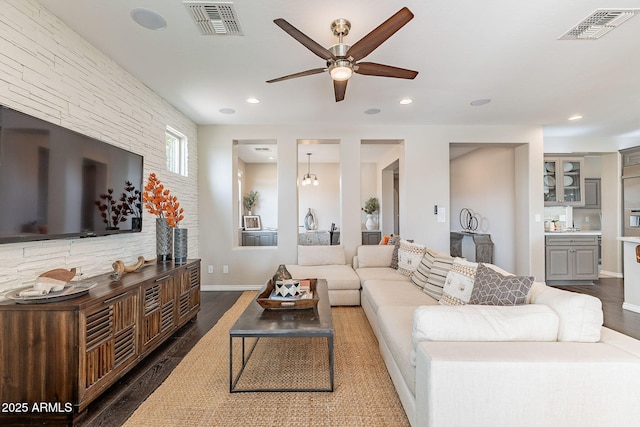 living room featuring recessed lighting, visible vents, and wood finished floors