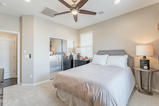 bedroom featuring visible vents, baseboards, ceiling fan, carpet flooring, and a closet