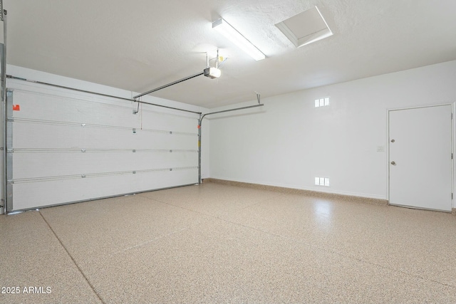 garage with a garage door opener and baseboards