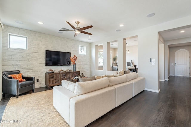 living room with visible vents, plenty of natural light, dark wood-style floors, and baseboards