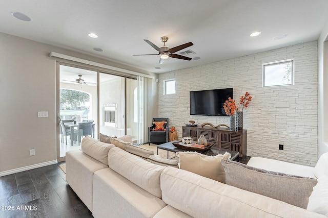 living room featuring plenty of natural light, baseboards, visible vents, and dark wood-style flooring